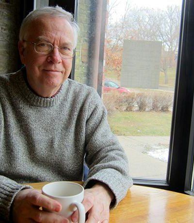 man sitting at table with coffee