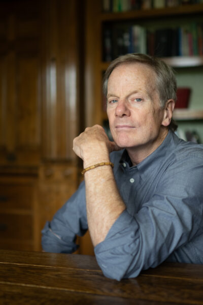 Nationally renowned recovery advocate and New-York Times Bestselling author William Cope Moyers seated at a table in a library.